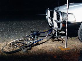 bicycle dragged out from underneath vehicle